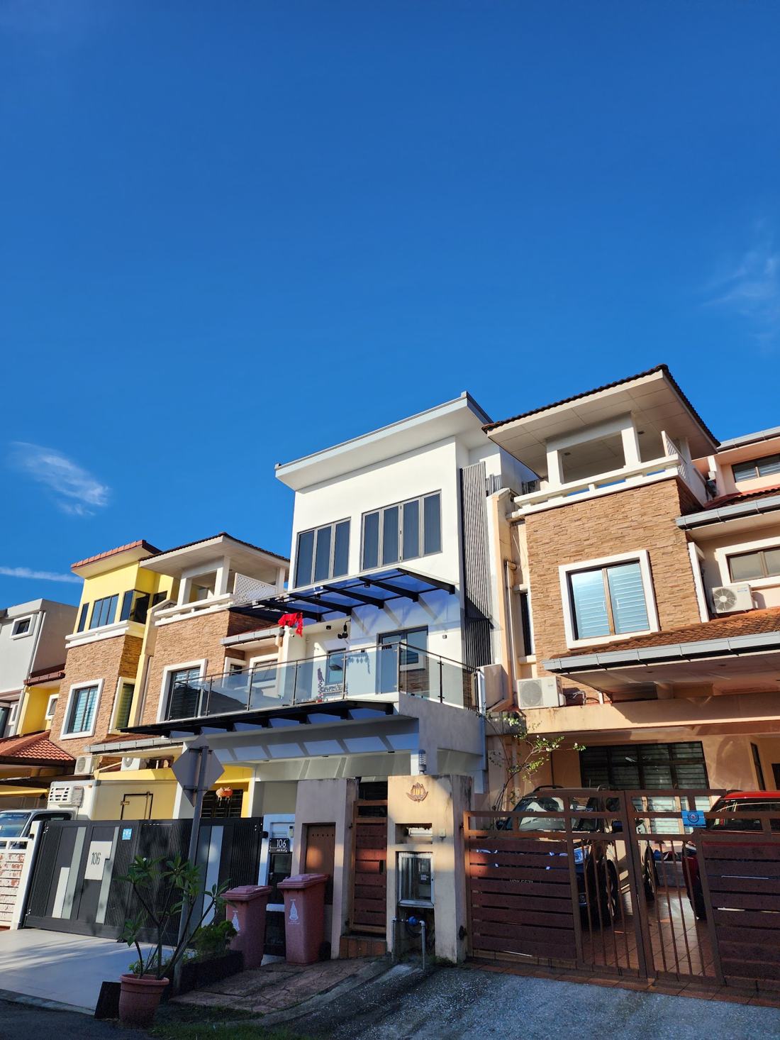 Terrace house exterior with glass canopy